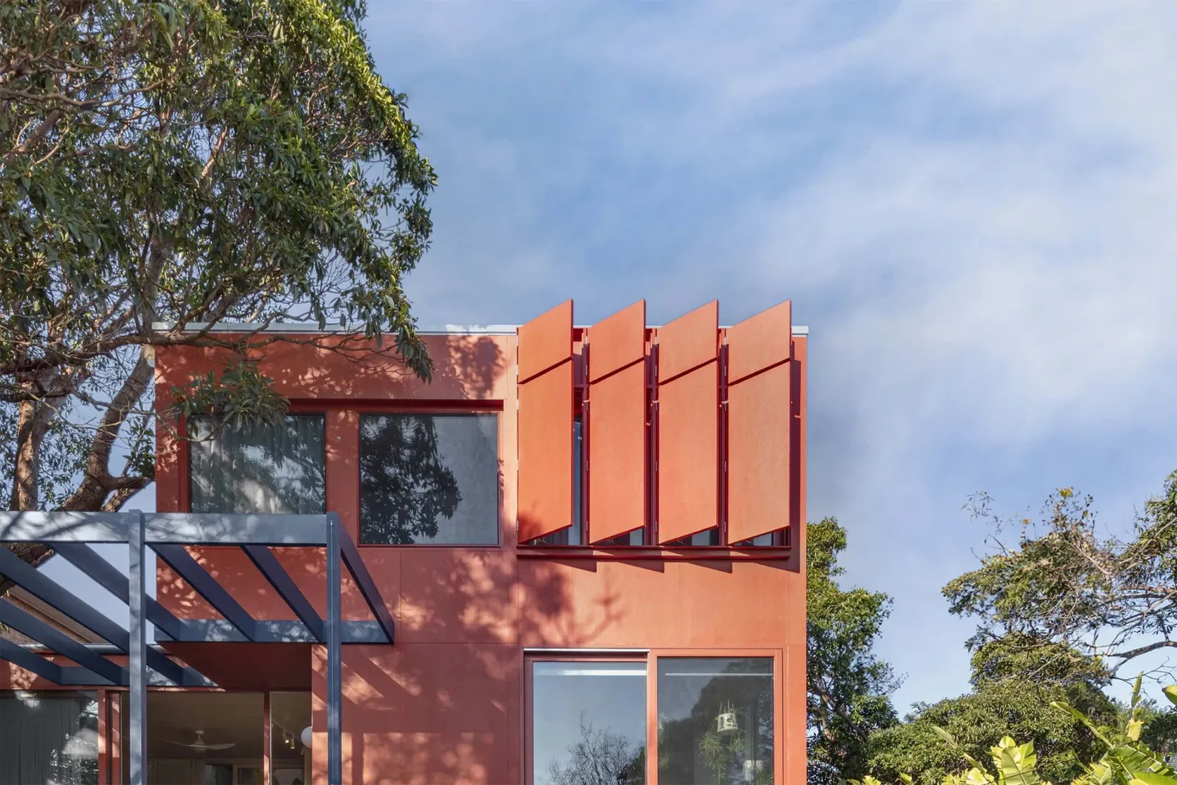 House clad in red James Hardie panels